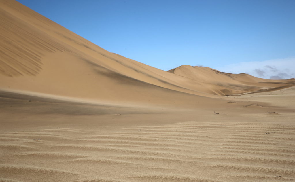 Perfect clean sand dune with iron deposits showing, and quarts gravel in the foreground.