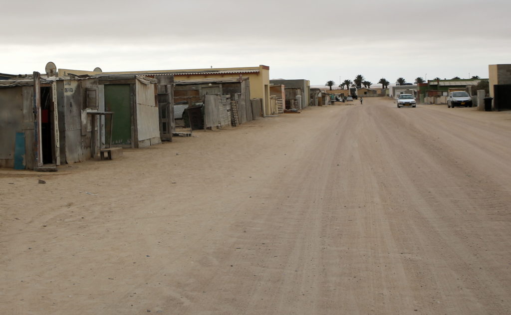 Street Scene in Kuisebmond, with the dunes and palm trees in the background